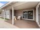 Covered patio featuring outdoor seating, with sliding door access to the home's interior at 1036 S 75Th St, Mesa, AZ 85208