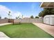 This serene backyard features lush green grass, mature trees, and a picnic table at 1036 S 75Th St, Mesa, AZ 85208