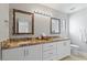 Elegant bathroom with double sinks, granite countertops, and decorative framed mirrors at 1036 S 75Th St, Mesa, AZ 85208