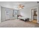Bright bedroom with a full bed and a doorway to a bathroom at 1036 S 75Th St, Mesa, AZ 85208