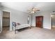 Spacious bedroom with neutral tones, carpet flooring, ceiling fan, and furniture at 1036 S 75Th St, Mesa, AZ 85208