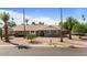 A charming home featuring desert landscaping and mature palm trees at 1036 S 75Th St, Mesa, AZ 85208
