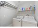 Clean laundry room with modern washer and dryer units, plus shelving for storage at 1036 S 75Th St, Mesa, AZ 85208