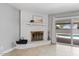 Living room with white brick fireplace and sliding glass doors to the outdoor pool area at 1036 S 75Th St, Mesa, AZ 85208