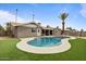 A refreshing pool is surrounded by lush green grass and mature landscaping at 1036 S 75Th St, Mesa, AZ 85208