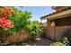 Enclosed yard featuring brick pavers, planters, and an abundance of colorful bougainvillea at 10420 N 10Th St # 2, Phoenix, AZ 85020