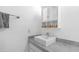 Bright bathroom features a gray countertop, white sink, and a matching mirror and cabinet at 10420 N 10Th St # 2, Phoenix, AZ 85020