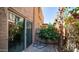 Outdoor patio with sliding glass doors surrounded by colorful, mature greenery at 10420 N 10Th St # 2, Phoenix, AZ 85020