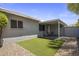 This backyard features an outdoor seating area, a grassy patch and a block fence for privacy at 1050 S Stapley Dr # 62, Mesa, AZ 85204