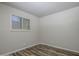 This cozy bedroom features a wood-look floor and a window that provides ample natural light at 1050 S Stapley Dr # 62, Mesa, AZ 85204