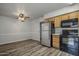 Cozy kitchen featuring stainless steel refrigerator, black appliances and easy flow to the dining area at 1050 S Stapley Dr # 62, Mesa, AZ 85204