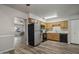 Efficient kitchen featuring stainless steel refrigerator, wood cabinets and easy flow to the living area at 1050 S Stapley Dr # 62, Mesa, AZ 85204