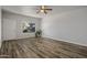 Open living room featuring luxury vinyl plank flooring, ceiling fan and large window offering great natural light at 1050 S Stapley Dr # 62, Mesa, AZ 85204