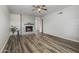 Bright living room featuring luxury vinyl plank flooring and decorative fireplace, with view to dining area at 1050 S Stapley Dr # 62, Mesa, AZ 85204
