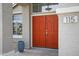 Close-up of the double front door with sidelight windows under a hanging light fixture and house number at 115 W El Freda Rd, Tempe, AZ 85284