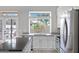 Kitchen featuring stainless appliances, granite countertops, ample natural light, and backyard views at 115 W El Freda Rd, Tempe, AZ 85284