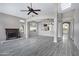 Bright living room with fireplace, skylight and ceiling fan that opens to other areas at 115 W El Freda Rd, Tempe, AZ 85284