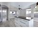 Spacious living room featuring wood-look tile floors, and access to the Kitchen at 115 W El Freda Rd, Tempe, AZ 85284