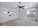 Light-filled living room with wood flooring, a ceiling fan, and large window views at 115 W El Freda Rd, Tempe, AZ 85284
