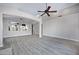 Open-concept living room featuring a ceiling fan, arched openings, wood flooring, and neutral walls at 115 W El Freda Rd, Tempe, AZ 85284