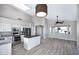 Spacious living room featuring wood-look tile floors, and access to the Kitchen at 115 W El Freda Rd, Tempe, AZ 85284