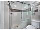 Tiled shower with glass door and a pebble floor drain in the bathroom at 115 W El Freda Rd, Tempe, AZ 85284