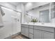 Bathroom with glass enclosed shower and double sink vanity at 11574 W Luxton Ln, Avondale, AZ 85323