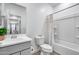 Bathroom featuring modern vanity with dual sinks and a shower/tub combo at 11574 W Luxton Ln, Avondale, AZ 85323