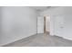View of empty bedroom features carpet flooring, neutral walls, and two white doors at 11574 W Luxton Ln, Avondale, AZ 85323
