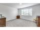 Bedroom with neutral carpet, and window with wood furniture at 11574 W Luxton Ln, Avondale, AZ 85323