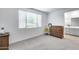 Bedroom with neutral carpet, window and wood furniture at 11574 W Luxton Ln, Avondale, AZ 85323