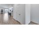 View of hallway shows modern open floor plan with kitchen, dining, and hallway at 11574 W Luxton Ln, Avondale, AZ 85323