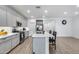 Well-lit kitchen with gray cabinets, stainless steel appliances, and a quartz island perfect for cooking and entertaining at 11574 W Luxton Ln, Avondale, AZ 85323