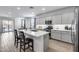 Stylish kitchen features modern cabinets, quartz countertops, stainless appliances, island with seating at 11574 W Luxton Ln, Avondale, AZ 85323