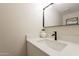 Elegant half-bath with white vanity, vessel sink, black faucet and modern mirror at 1301 N 44Th St, Phoenix, AZ 85008