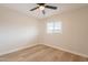 Bright, empty bedroom with wood floors, ceiling fan and a large window at 1301 N 44Th St, Phoenix, AZ 85008