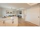 Dining area adjacent to the kitchen with modern lighting, white cabinets, and stainless steel appliances at 1301 N 44Th St, Phoenix, AZ 85008