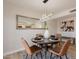 Bright dining room with a modern light fixture, a large framed mirror, and neutral decor at 1301 N 44Th St, Phoenix, AZ 85008