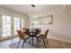Chic dining room boasts a round table, modern light fixture, and access to the outdoors at 1301 N 44Th St, Phoenix, AZ 85008