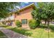 Brick townhouse with mature landscaping, healthy green lawn and sidewalk access at 1301 N 44Th St, Phoenix, AZ 85008