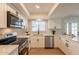 Bright, updated kitchen with stainless steel appliances, white cabinets, and quartz countertops at 1301 N 44Th St, Phoenix, AZ 85008
