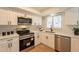 Well-equipped kitchen features stainless steel appliances, white cabinets, and updated countertops at 1301 N 44Th St, Phoenix, AZ 85008