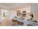 Well-lit kitchen with white cabinets, stainless steel appliances, and breakfast bar seating at 1301 N 44Th St, Phoenix, AZ 85008