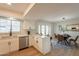 Open-concept kitchen with stainless steel appliances and ample counter space, adjacent to dining area at 1301 N 44Th St, Phoenix, AZ 85008