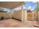 Covered patio area showcasing stone flooring, neutral wall, and gated entrance at 1301 N 44Th St, Phoenix, AZ 85008