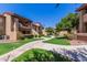 Apartment complex with well-manicured lawn and sidewalk paths at 1351 N Pleasant Dr # 2051, Chandler, AZ 85225