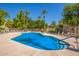 Beautiful community pool features inviting blue water, chairs for lounging, and desert landscaping at 1351 N Pleasant Dr # 2051, Chandler, AZ 85225