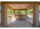 Covered outdoor grilling area with a built-in grill, counter space, and signage at 1351 N Pleasant Dr # 2051, Chandler, AZ 85225