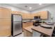 Well-lit kitchen with stainless appliances, black sink, and wood cabinets at 1351 N Pleasant Dr # 2051, Chandler, AZ 85225