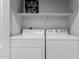 Laundry room features a full-size washer and dryer and overhead shelf at 1351 N Pleasant Dr # 2051, Chandler, AZ 85225